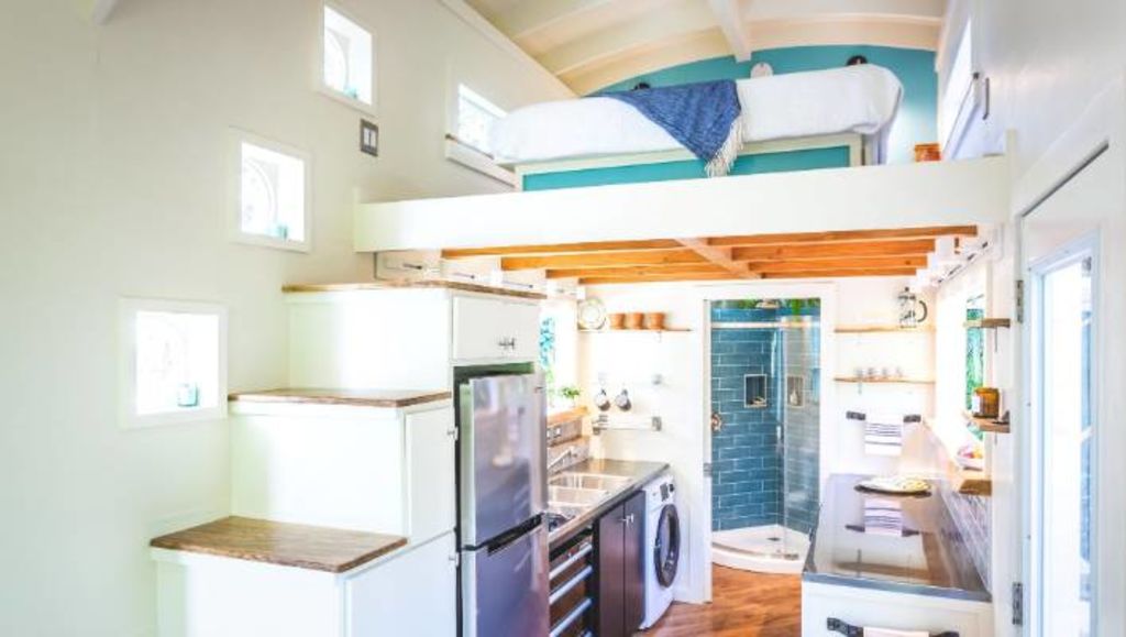 Stairs that double as storage areas, lead up to the bedroom. Photo: Paradise Tiny Homes