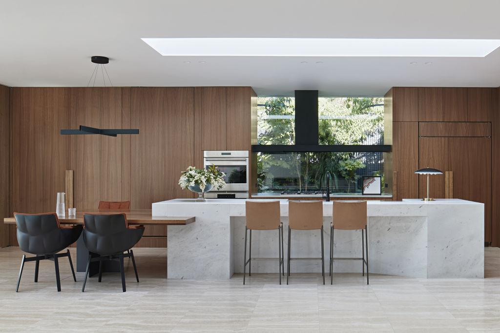 Behind the timber kitchen joinery are a series of secretive spaces. Photo: Shannon McGrath