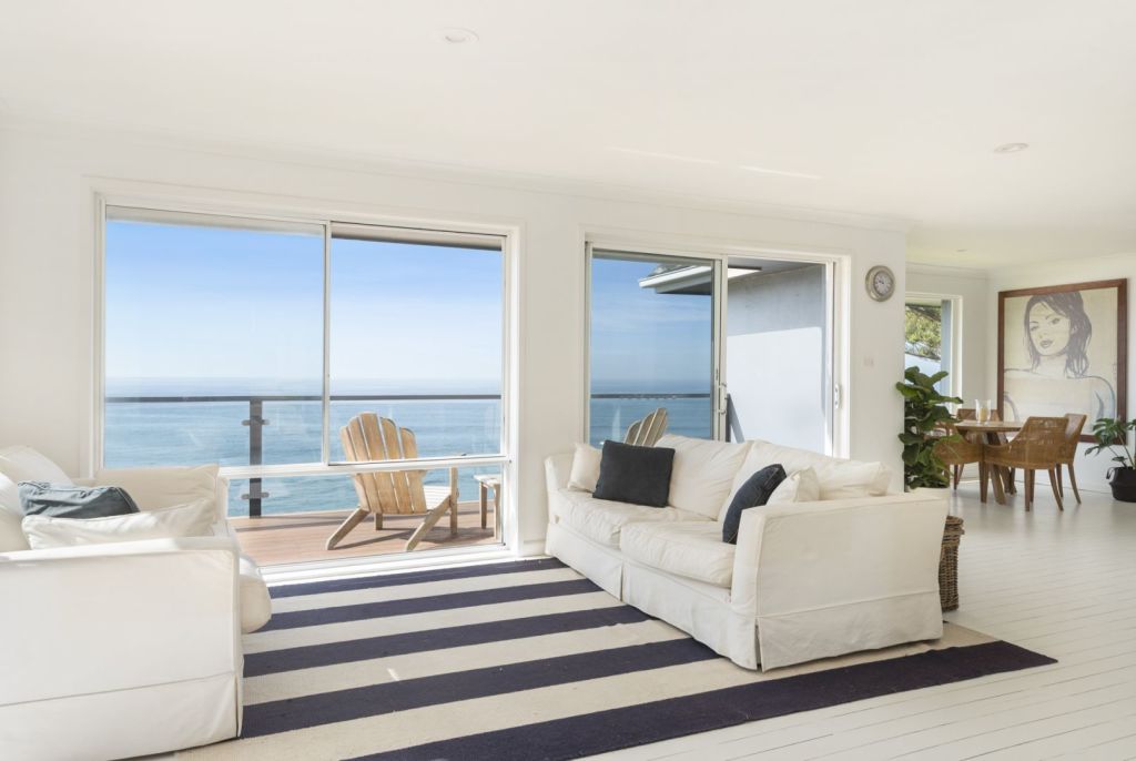The property spans two levels and has sweeping ocean views. Photo: Supplied