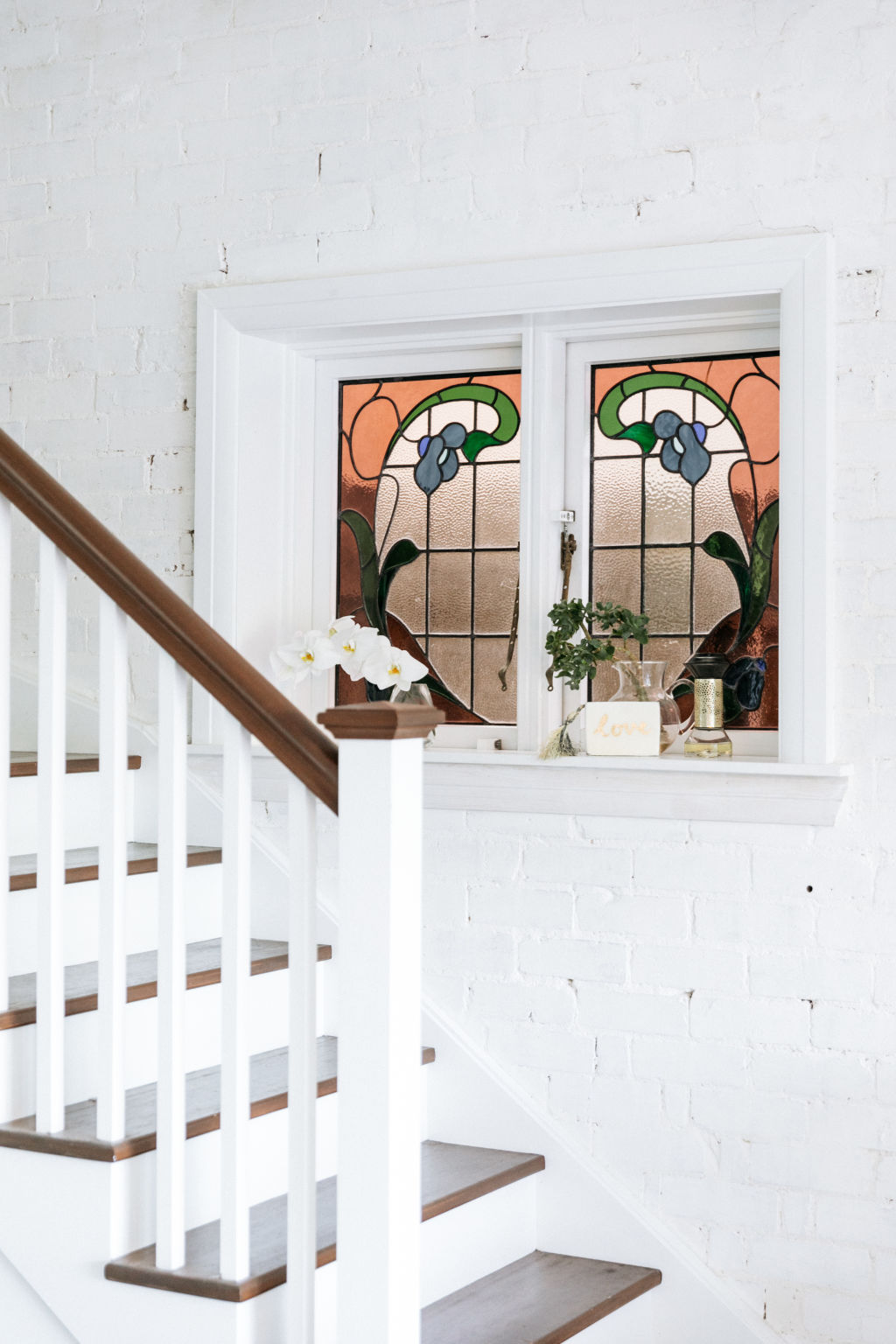 The merging of two eras is sweetly captured with an original leadlight window you find at the bottom of the stairwell. Photo: Caroline McCredie
