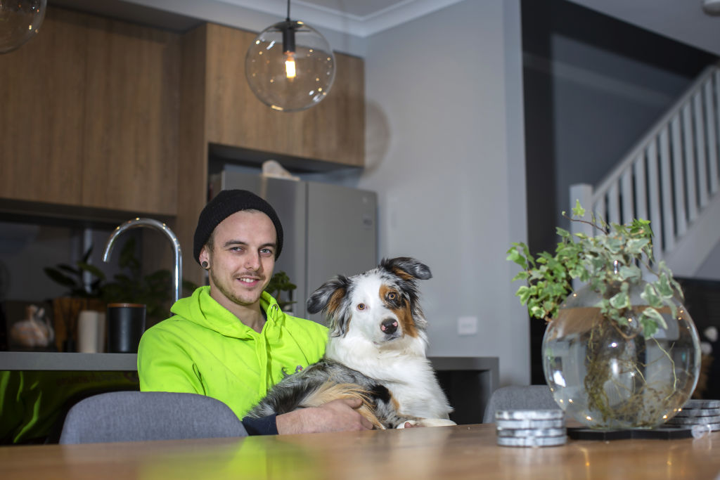 Josh Swanwick and his dog Maize in his recently sold Tarneit home. Photo: Stephen McKenzie
