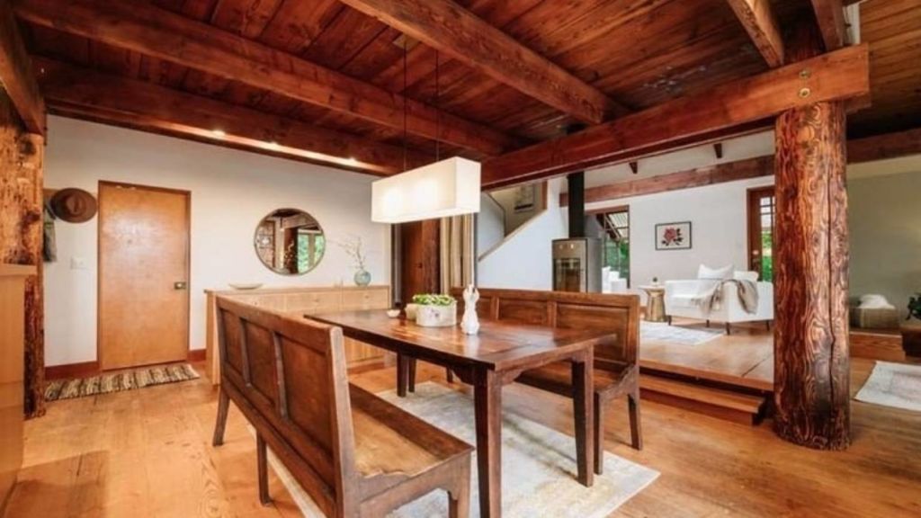 The living area includes four salvaged wood beams from a 100-year-old Douglas fir tree. Photo: Zillow/Erik Hecht