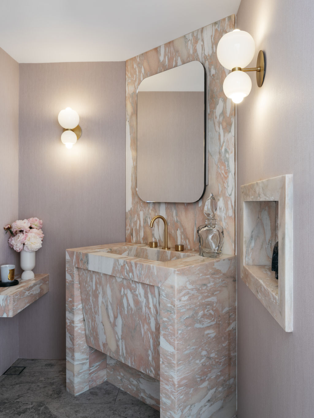 Beautiful archways provide glimpses into adjacent spaces, including a pretty pink powder room. Photo: Felix Forest