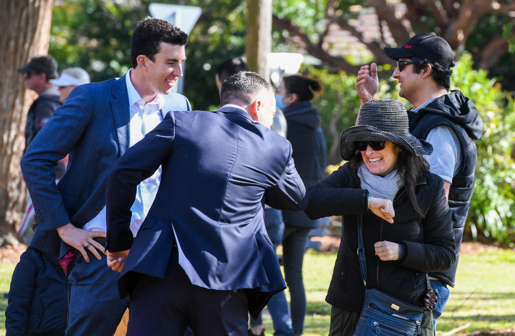 Ray White Georges River (L) Matt Brooks and Principal Agent Matt O'Shea elbow bump the happy buyers Shyrley and Gilberto Aleman after the hammer came down.  Photo: Peter Rae