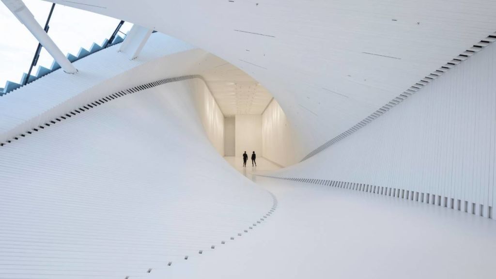 An all-white interior reinforces the sculptural form. Photo: Laurian Ghinitiou