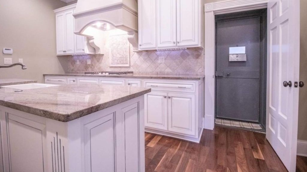It’s business as usual until you get to that ominous-looking door in the kitchen... Photo: Realtor.com