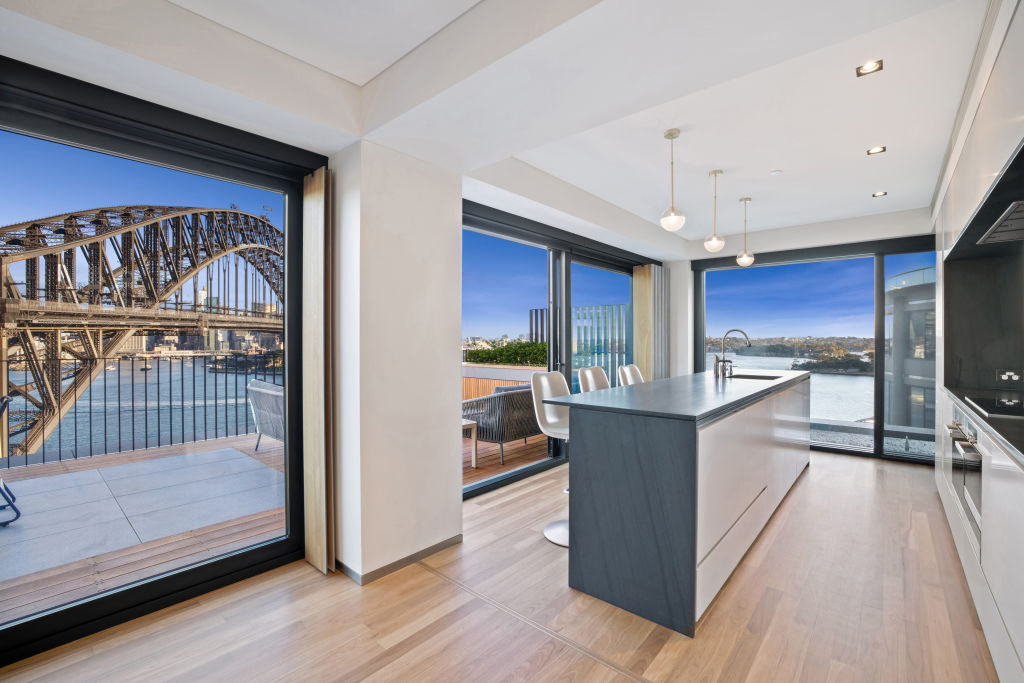 The kitchen has two dishwashers and fridges - and a mirrored splashback to enjoy the view at all times. Photo: Supplied