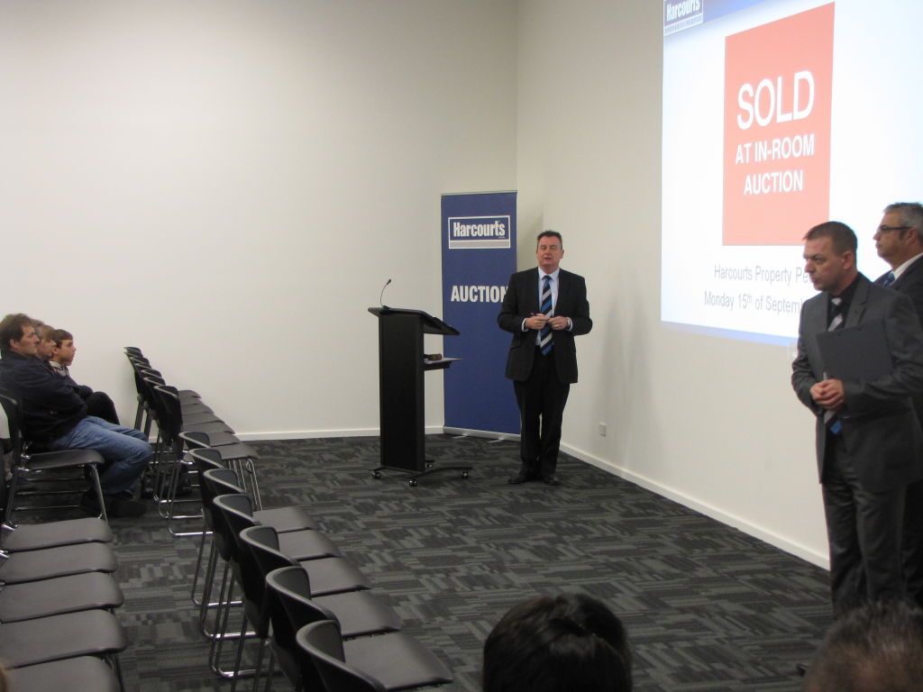 Greg Bolto, centre, of Harcourts Property People, is a firm believer in the upside of online auctions.