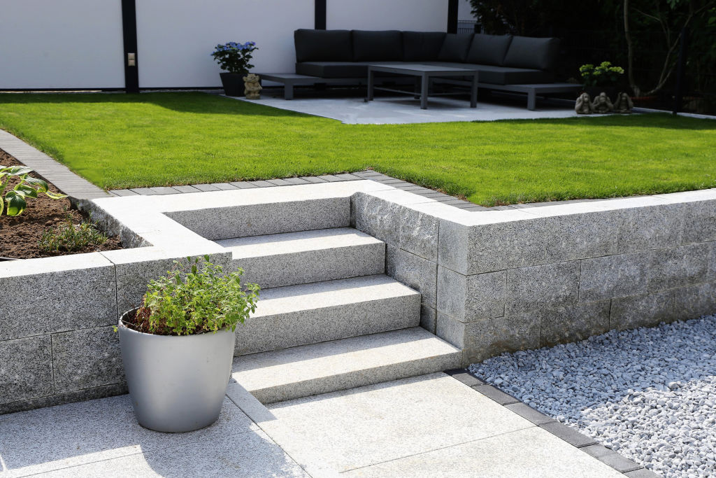 Retaining walls are ideal for landscaping sloped backyards, but it's worth consulting a professional to make sure yours lasts. Photo: iStock
