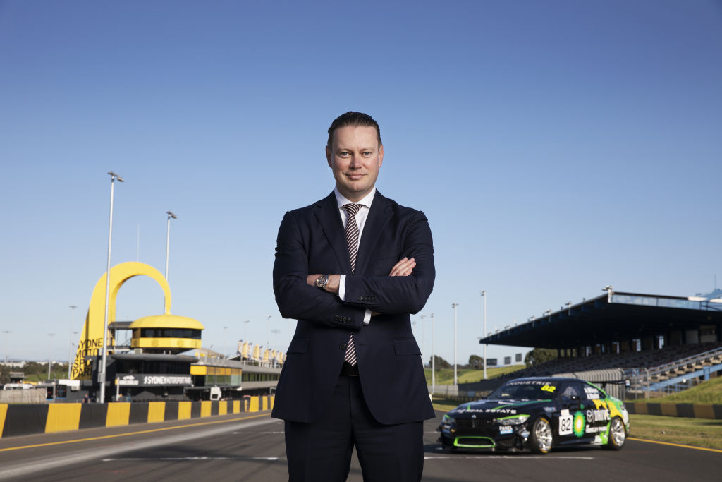 Adrian Wilson stands on the raceway at Sydney Motor Park, Eastern Creek, with his BMW M4 Series which is Production Sports Car which he races in the NSW State ProdSport Championships and the CUE Enduro Series. Photo: Jessica Hromas