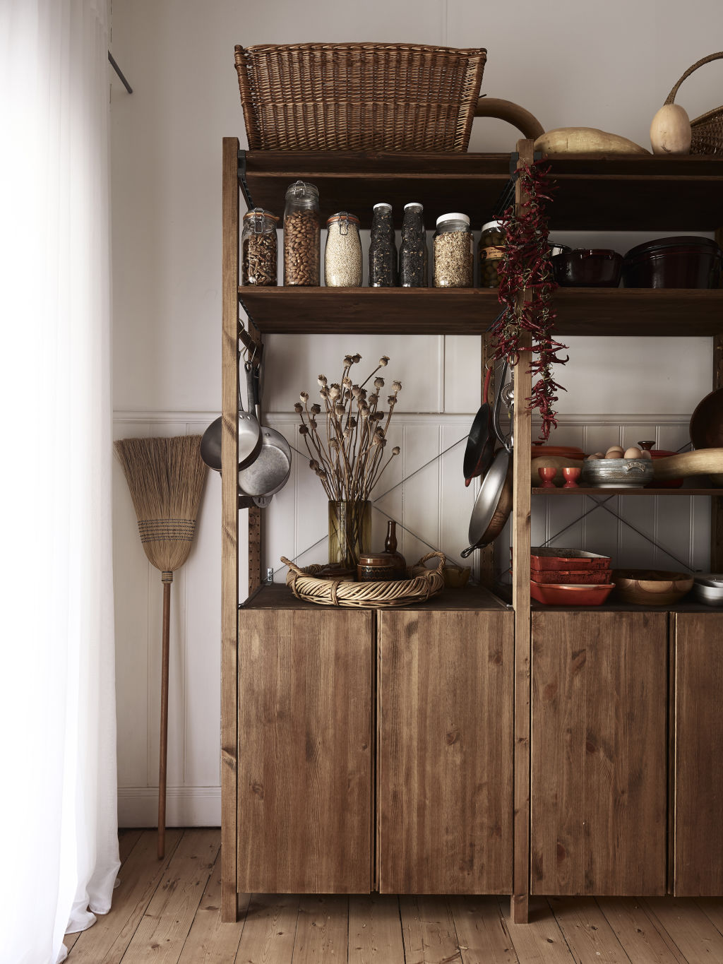 The larder features an Ikea IVAR storage system that’s been lovingly stained piece by piece.  Styling: Annie Portelli. Photo: Eve Wilson