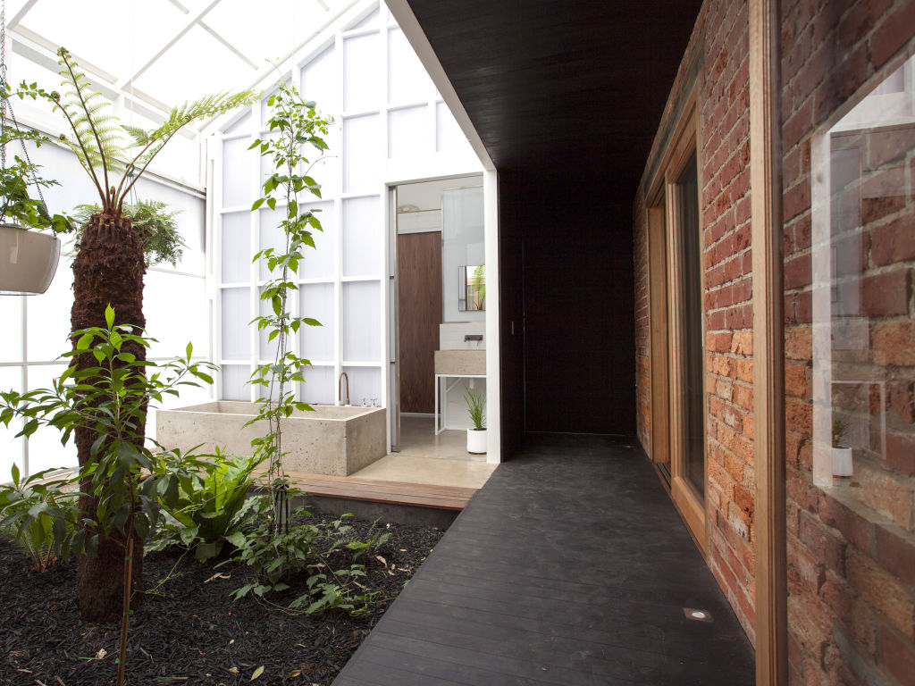 The hand-poured concrete bath is a feature in the internal garden.