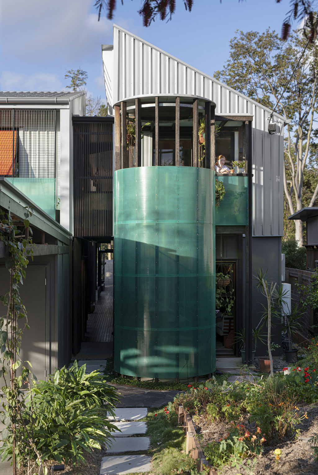 Encased in translucent green fibreglass the spiral stair is the entry to a small stand-alone flat. Photo: Mindi Cooke