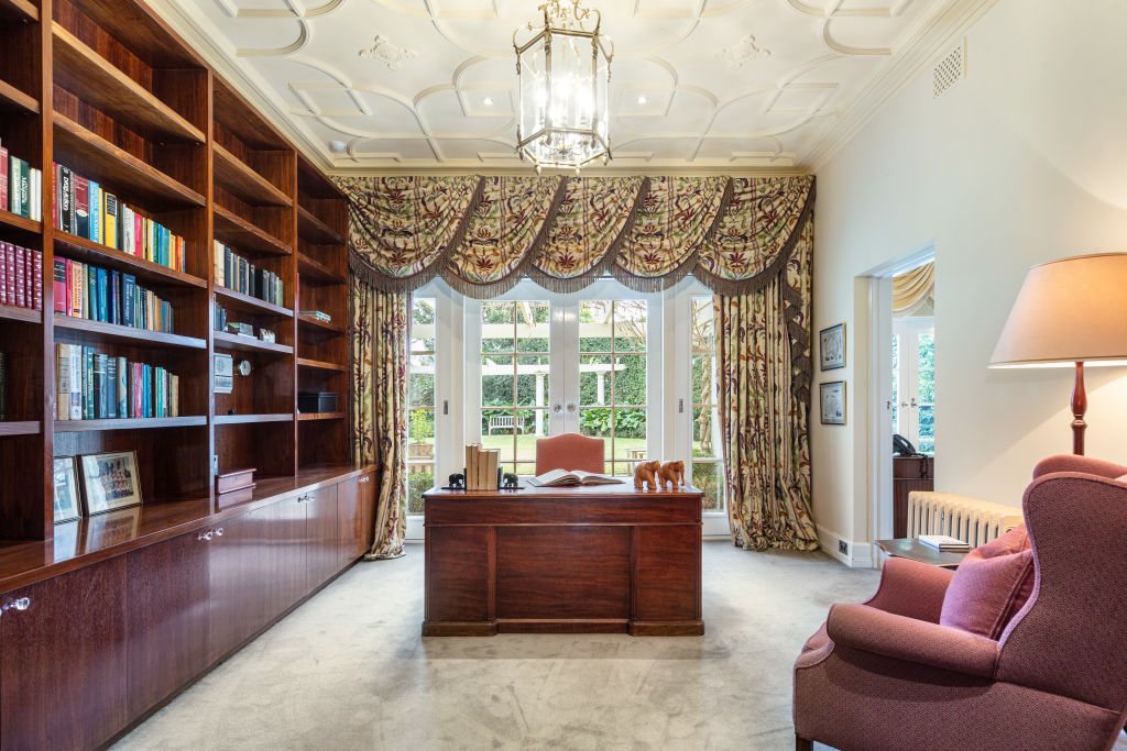 The large office and library lit by natural light from the lush gardens beyond. Photo: Kay &amp; Burton