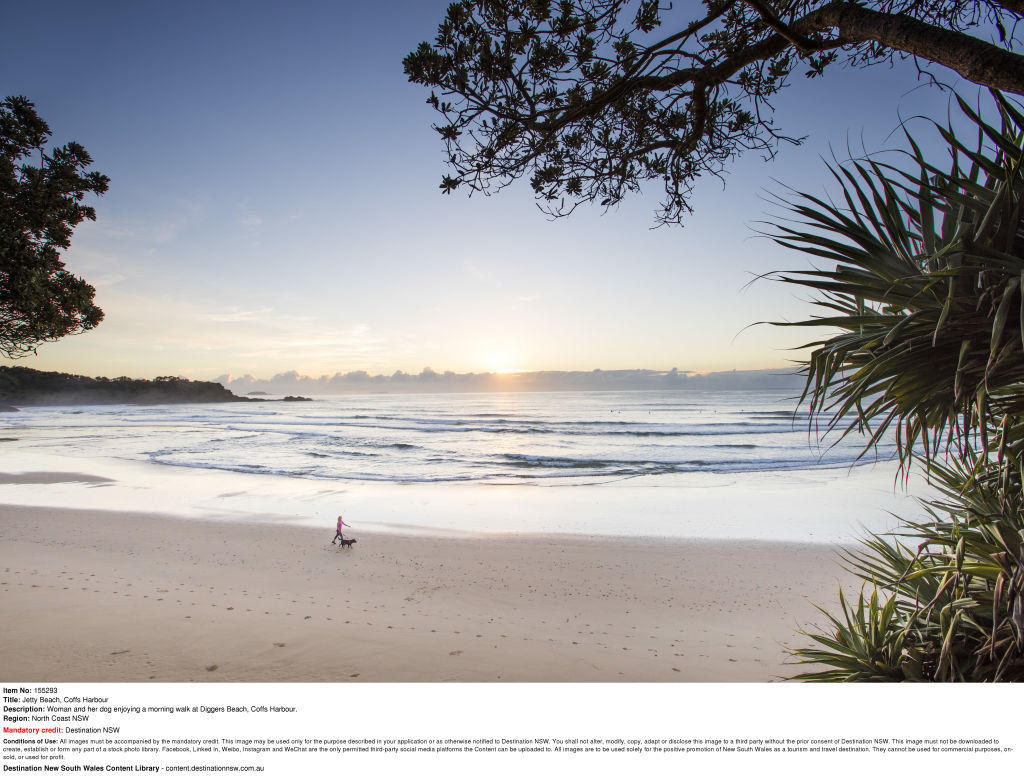 Woman and her dog enjoying a morning walk at Diggers Beach, Coffs Harbour. Photo: Dallas Kilponen