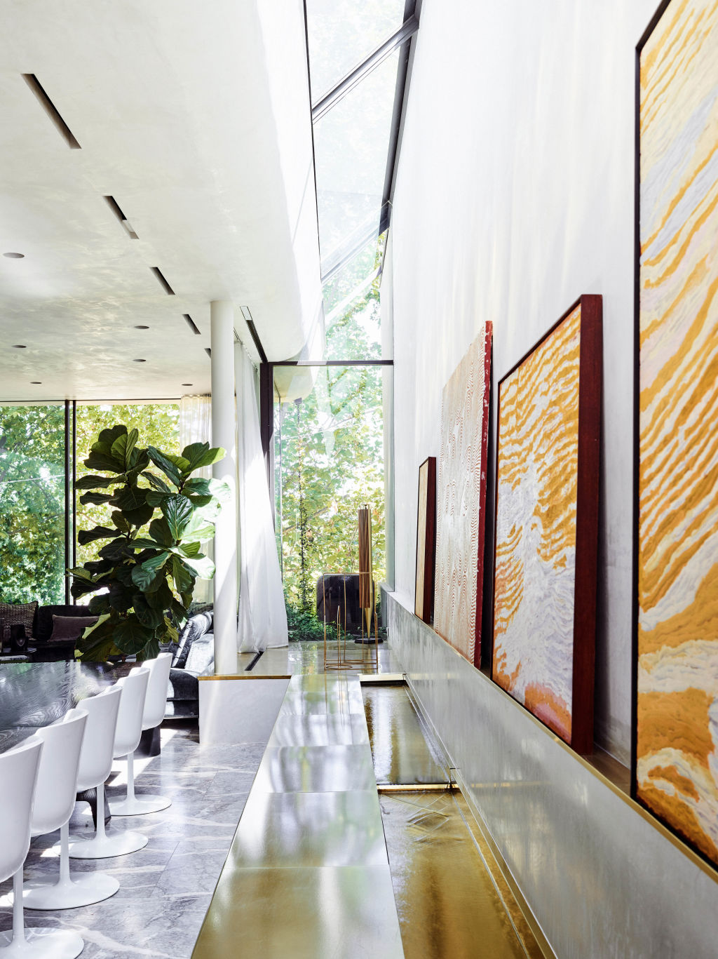 A brass-lined water feature flows through the living space. Photo: Kay & Burton
