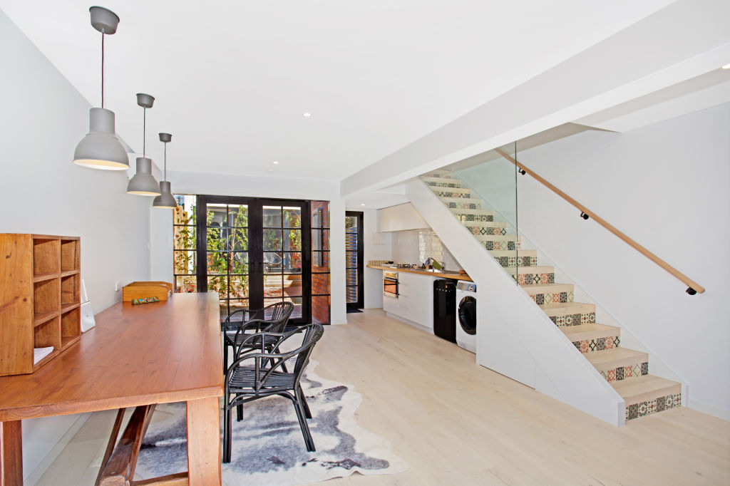 The Carlton North studio apartment by Gentrify has ample space for a kitchen, home office and bedroom and bathroom upstairs. Photo: Supplied