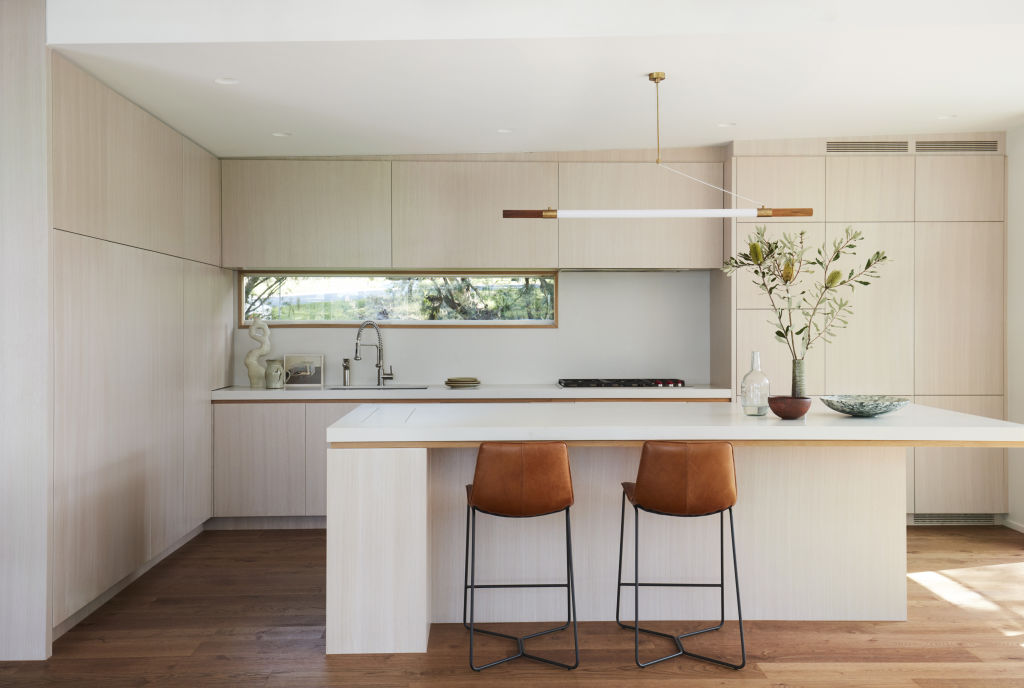 Fine timber detailed and matt stone benchtops are the hallmarks of the home's exquisite kitchen.  Photo: Supplied