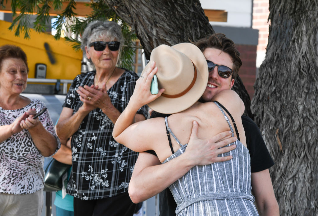The winning bidders embrace after the fall of the hammer. Photo: Peter Rae