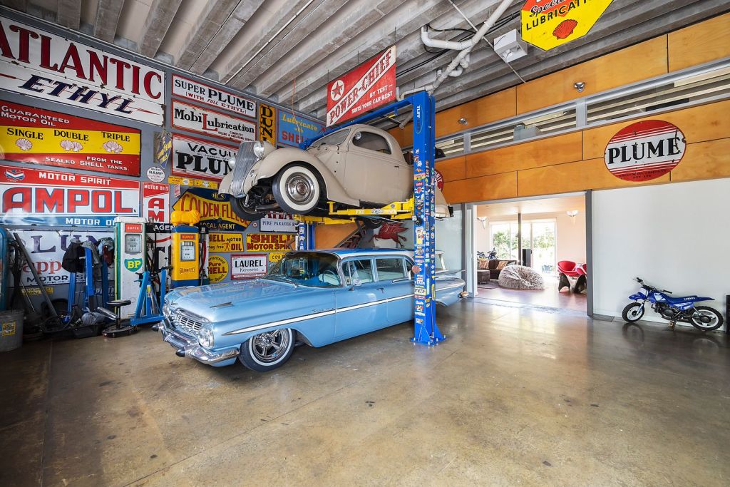 A large warehouse conversion in Kensington, which currently houses a vintage car collection, sold after auction. Photo: Nelson Alexander Flemington