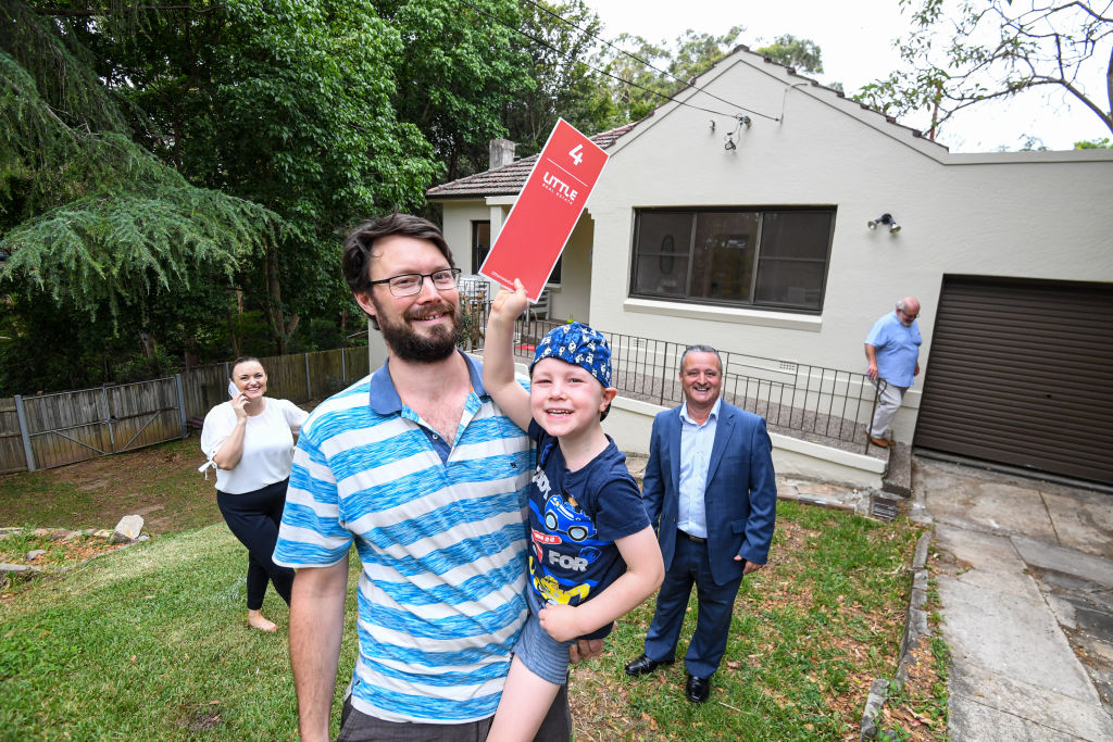 An offer of 'infinity' from Jamie Watters, 5, pictured with dad Alex Watters, stopped the auctioneer in his tracks. Photo: Peter Rae