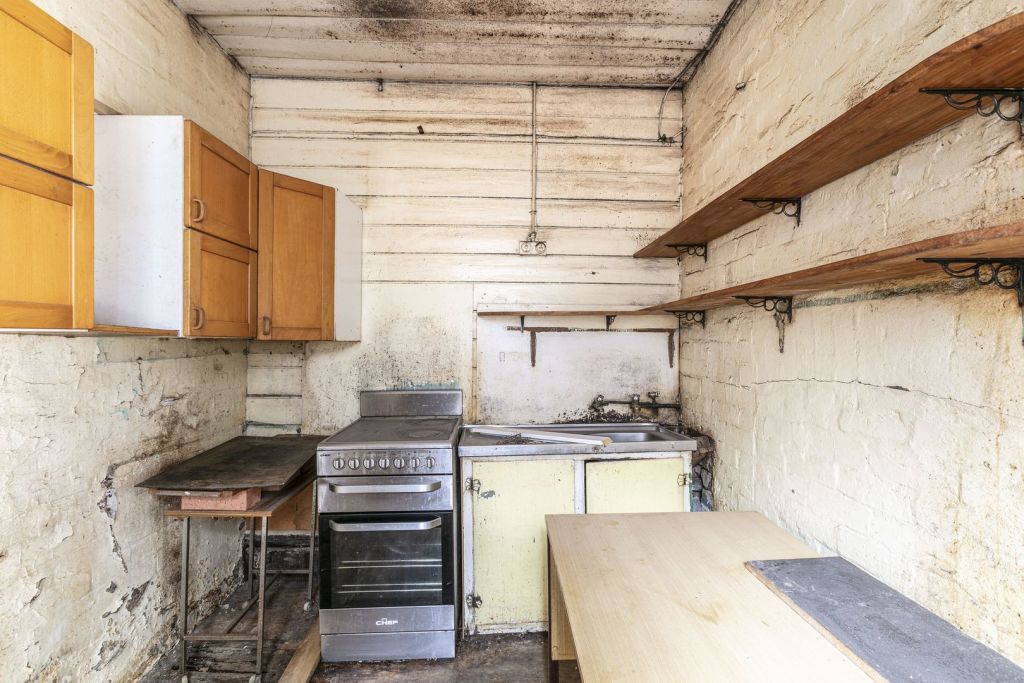 The kitchen at 179 Denison Street, Newtown, had seen better days. Photo: BresicWhitney Balmain
