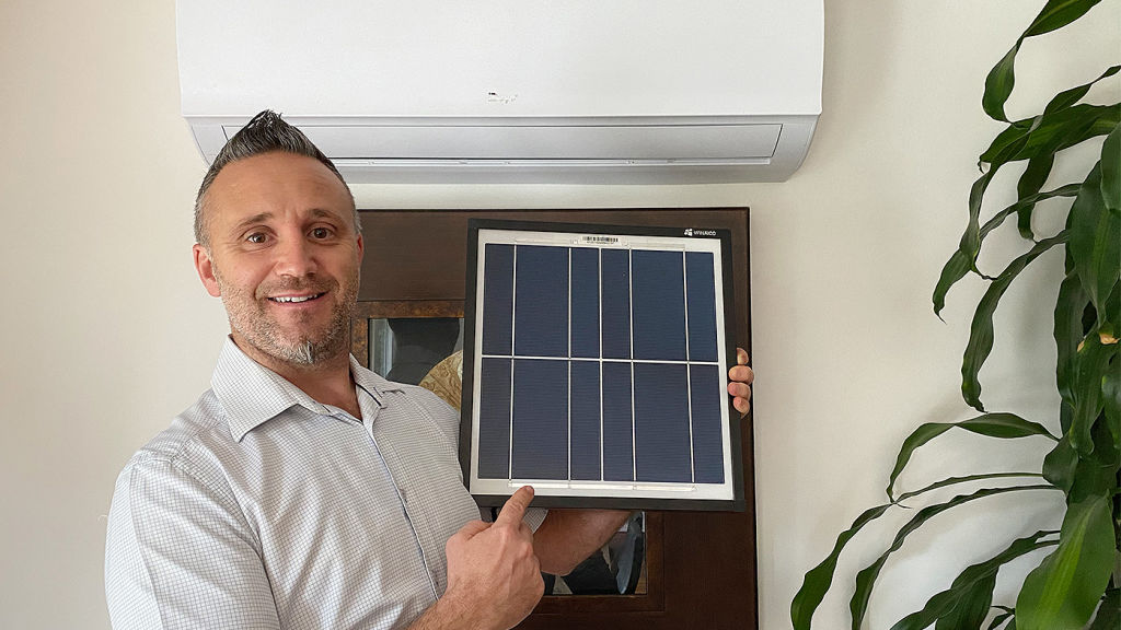 Rob Miravet of Solar ACDC with the solar-powered air conditioning unit. Photo: Supplied