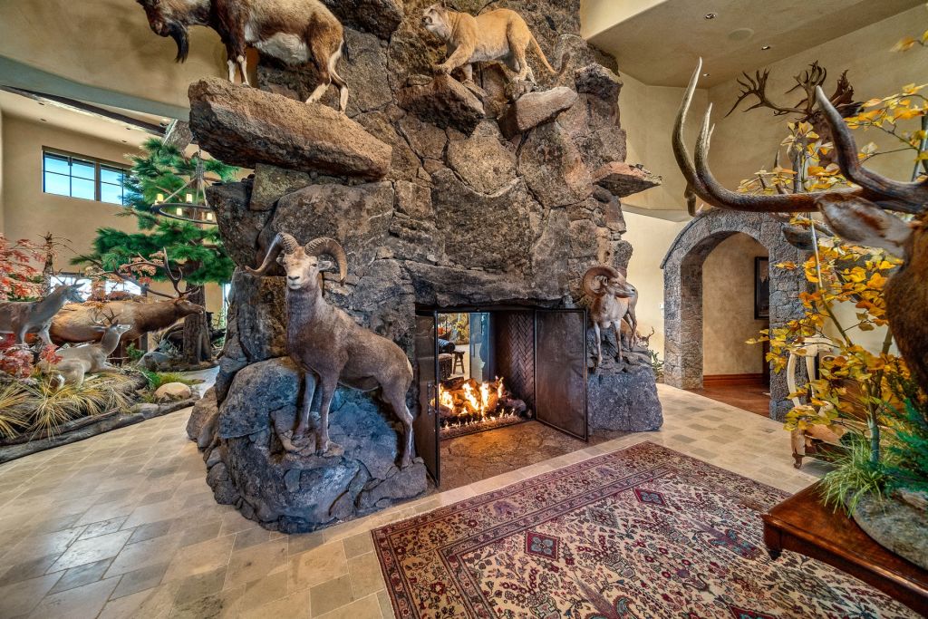 The fireplace is made with rocks from the property and decorated with stuffed animals which belong much further afield. Photo: Zillow/Cascade Sotheby's International Realty