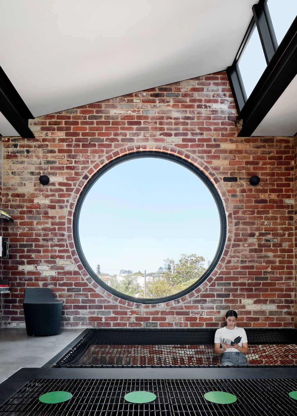 From inside and with a big circular window and suspended net for hanging out on, Brick House signals its intention to be playful.  Photo: Jack Lovel