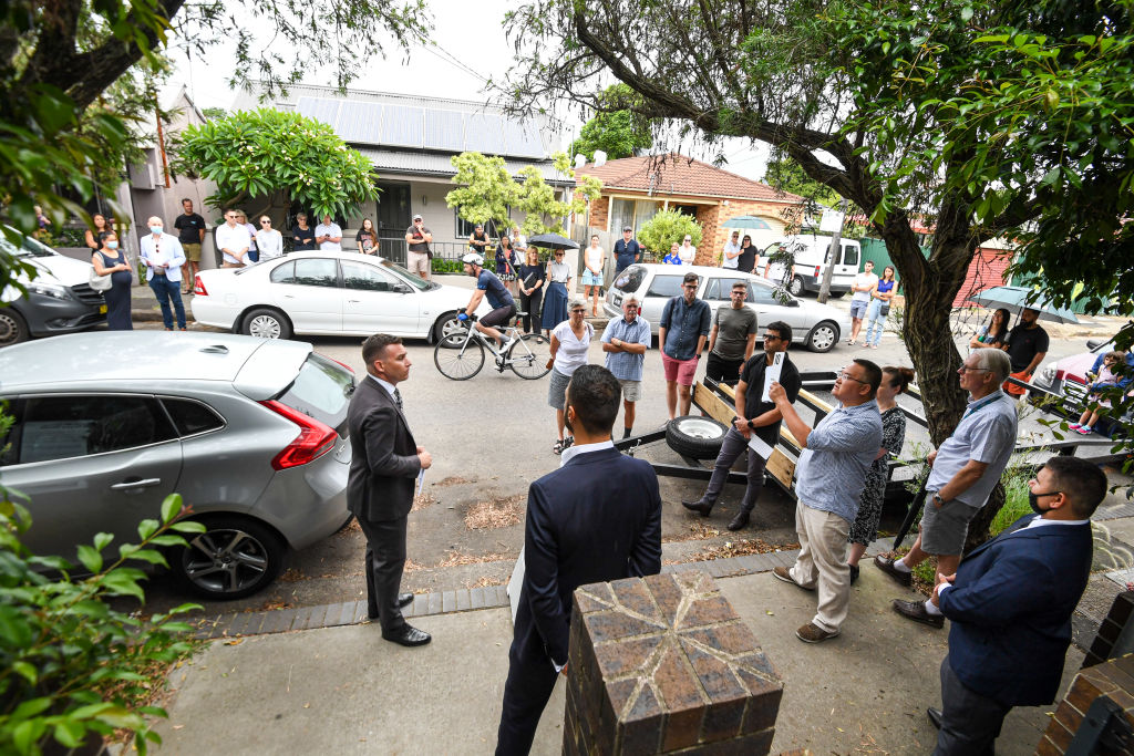 Dozens turned up to watch the St Peters house go under the hammer despite rainy weather on Saturday. Photo: Peter Rae