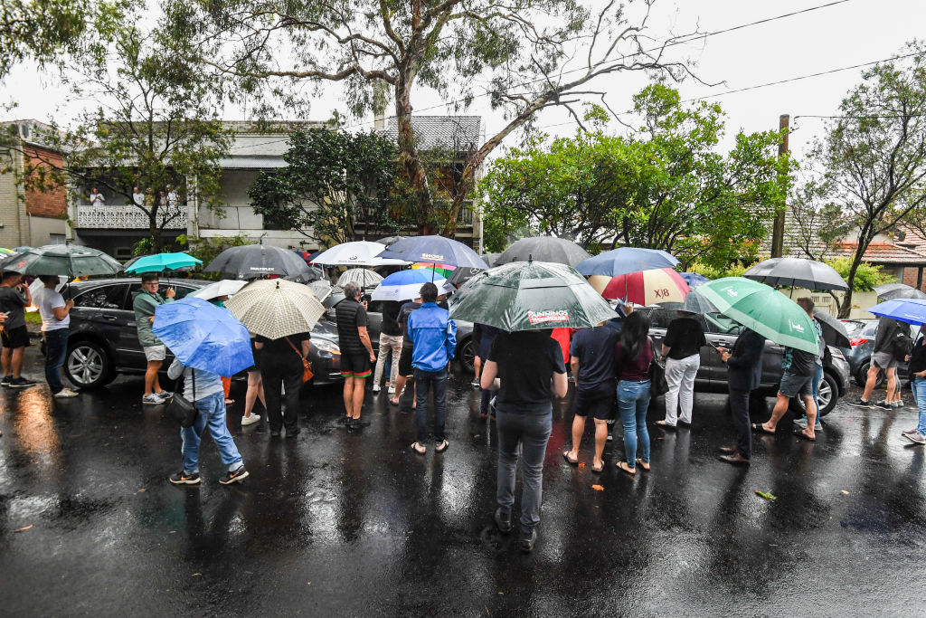The heavy rain did not stop dozens turning up to watch the sale. Photo: Peter Rae
