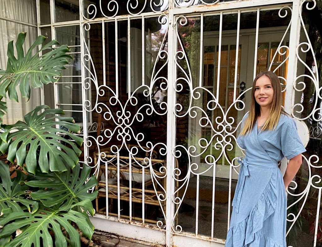 Krisi Patras at the wrought-iron-enclosed front door of Villa Italia. Photo: Supplied