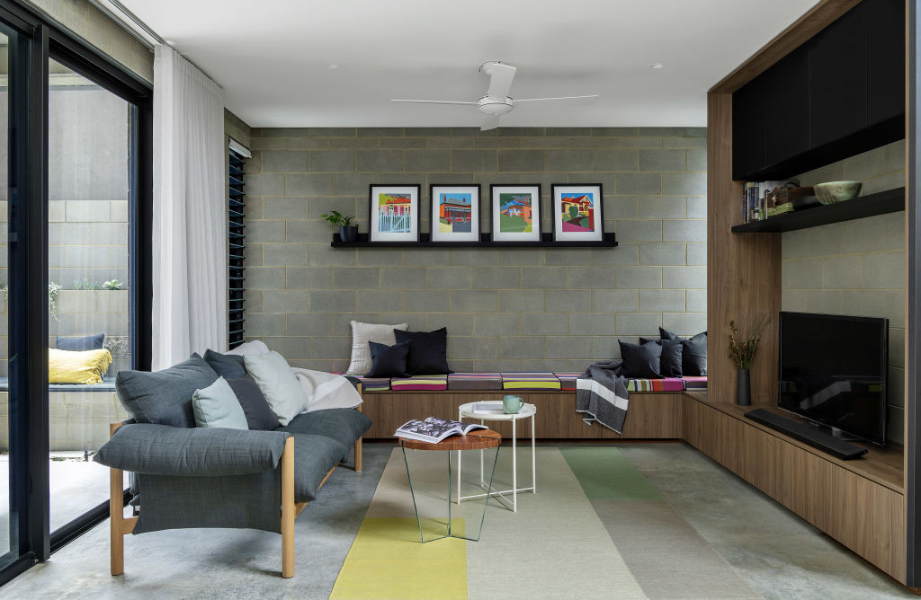 The bench seat in the living room has underseat drawers and extends to the outdoor area. Photo: Jody D'Arcy