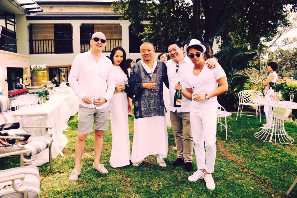Sam Kuizhang Guo (centre) pictured with guests at his White Party at the Windermere estate.