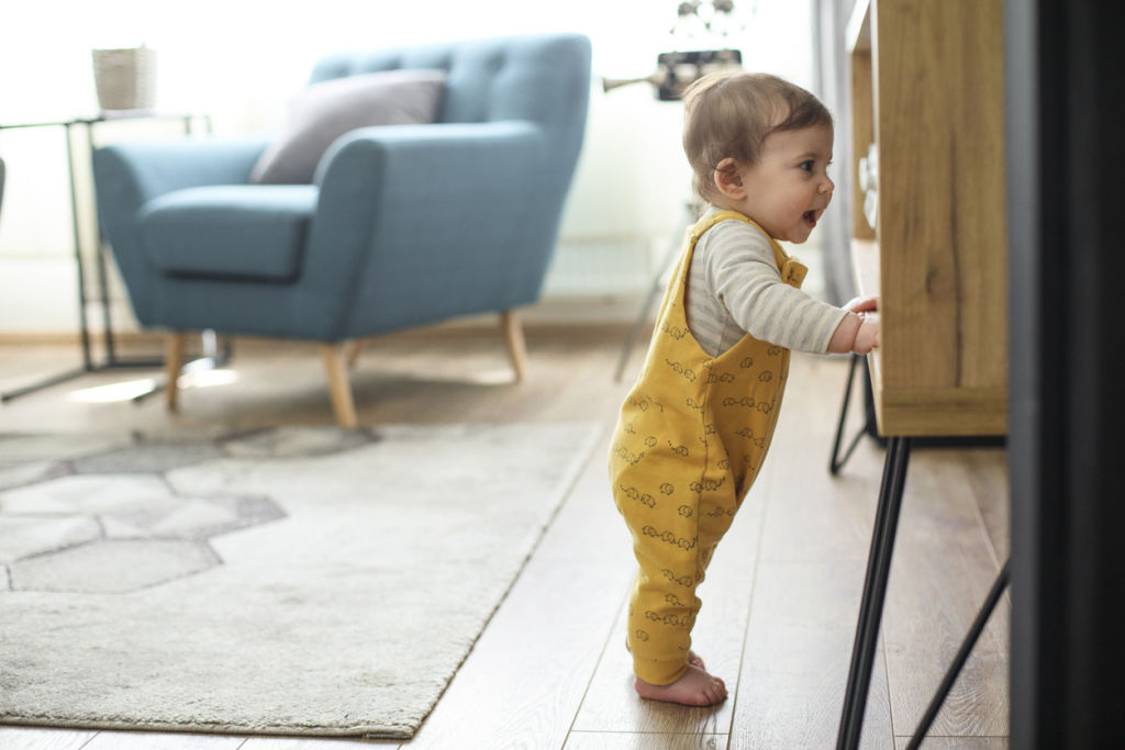 Children need ample opportunities to crawl and practice standing. Photo: iStock