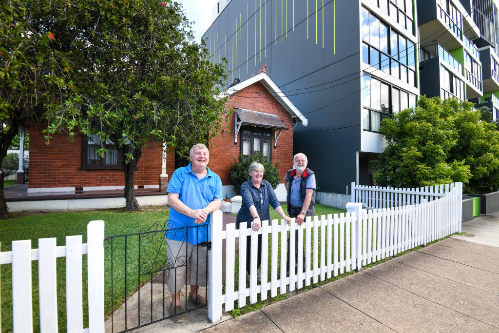 Mr Dickson's children Peter (left), Joanne and Greg in the front garden of the Kogarah home. Photo: Peter Rae