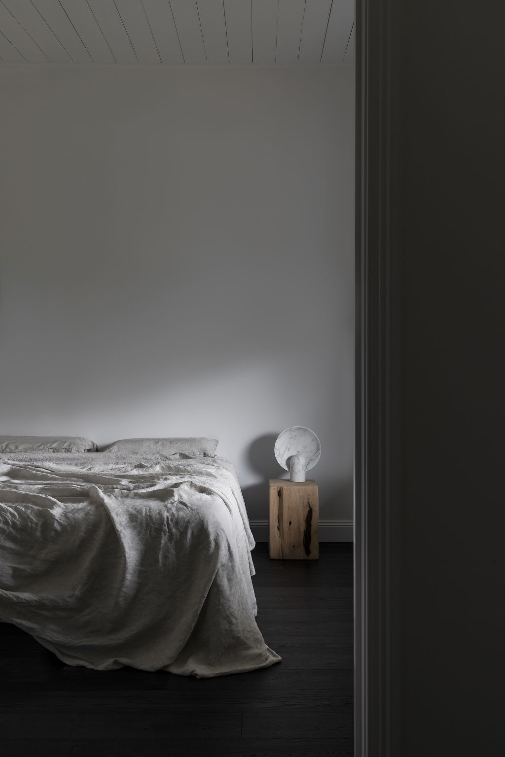 You'll find a minimalist colour palette in the bedrooms. Photo: Tim Kaye