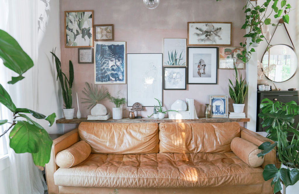 Add visual interest to a room by creating a photo wall. Photo: Stocksy