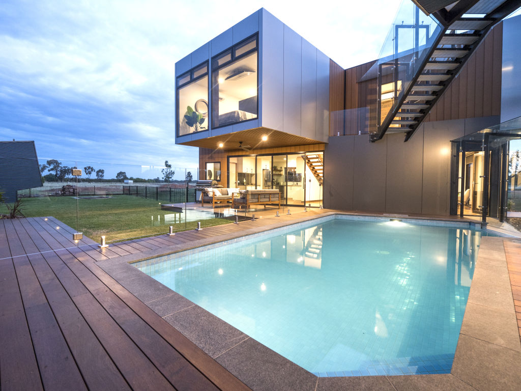 The living area and rumpus room open onto an outdoor barbecue deck and swimming pool. Photo: Serana Hunt-Hughes