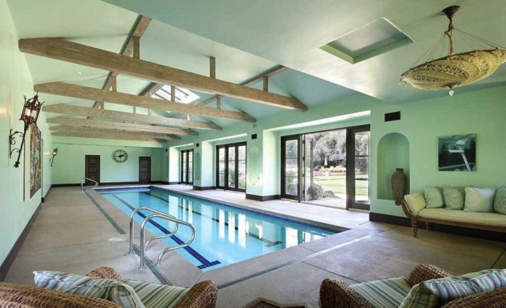 The property features indoor and outdoor swimming pools. Photo: Zillow/Dirt