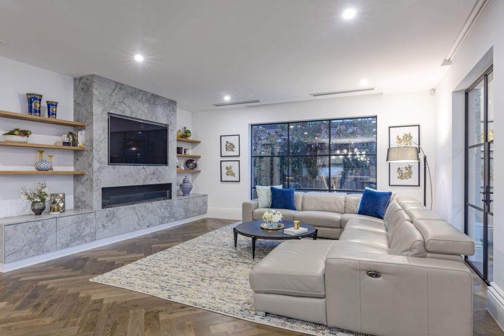 The couple added herringbone floors and designer light-fittings throughout the three-level home.