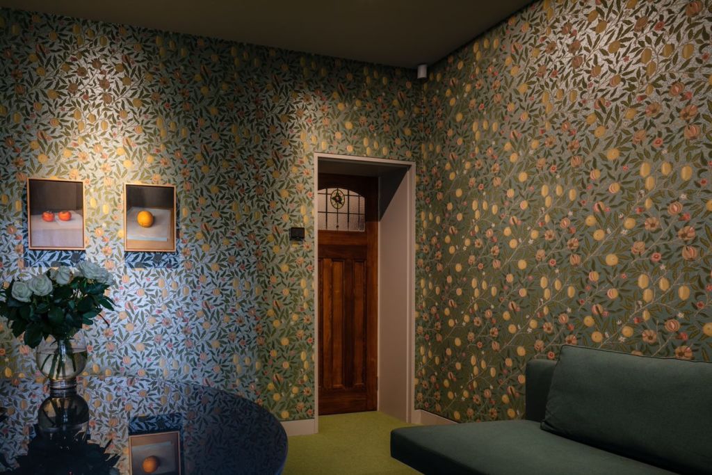 William Morris wallpaper and curtains make her study like an interior garden. Photo: Trevor Mein