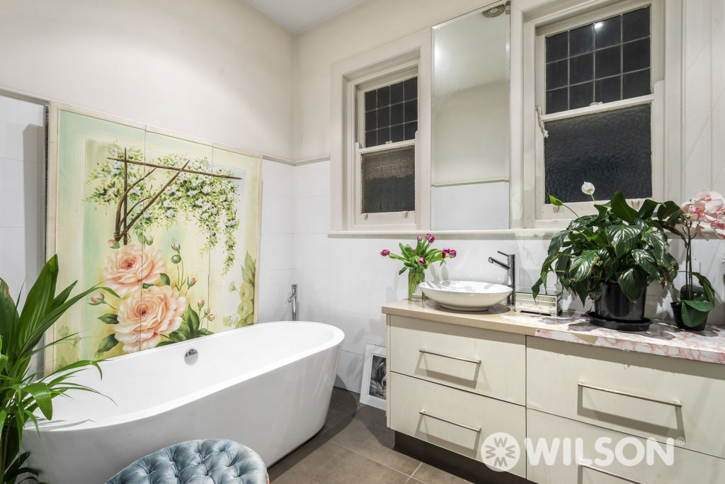 Alannah Hill's signature girlie florals adorn the bathroom of her St Kilda apartment.