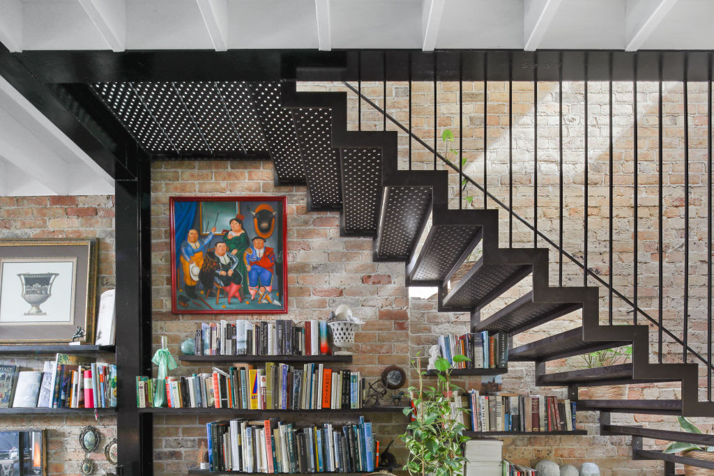 The perforated steel staircase doubles as a sculptural element that's best viewed from the kitchen and living spaces. Photo: Supplied