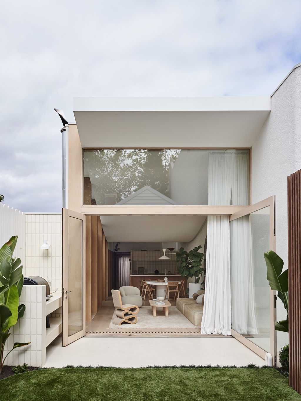 The house completely opens to the central courtyard, flooding the living room with light.  Photo: Eve Wilson. Styling: Annie Portelli