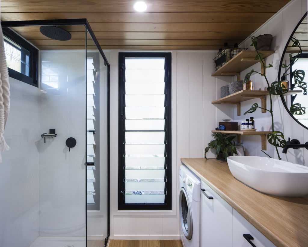 The bathroom holds a shower, composting toilet and front-loading washing machine. Photo: Lucas Muro