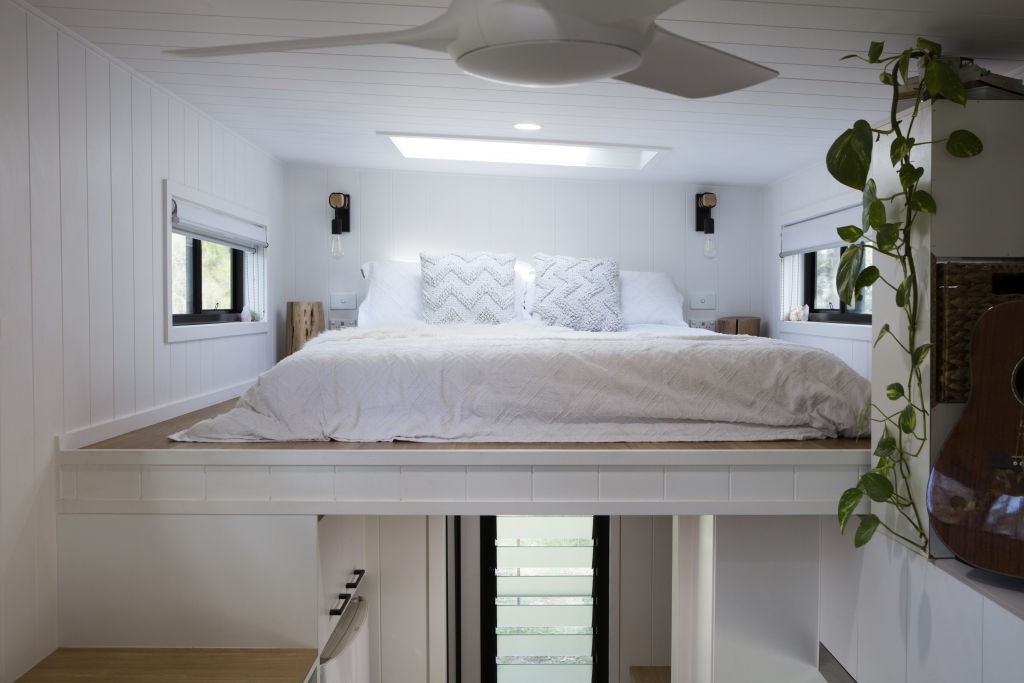 Amy and Greg's loft bedroom has windows alongside and a skylight above, through which they can see the stars. Photo: Lucas Muro