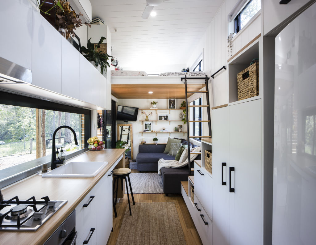 The kitchen has a full-size fridge and oven, a two-burner stove and pull-out pantry. Photo: Lucas Muro