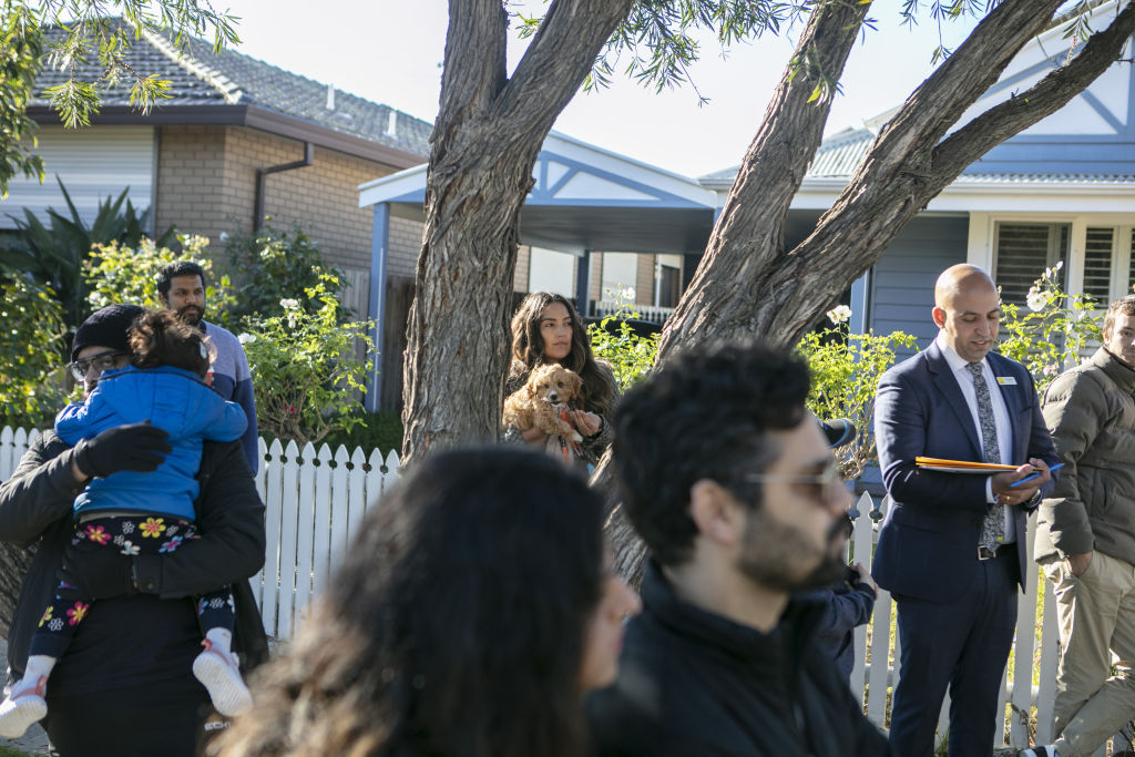 About 40 people gathered to watch the three-bedroom home at 18 Robert Street in Spotswood go under the hammer. Photo: Stephen McKenzie