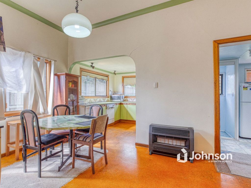 The house at 16 Kianawah Road Wynnum West features a lime-green kitchen and an orange floor.